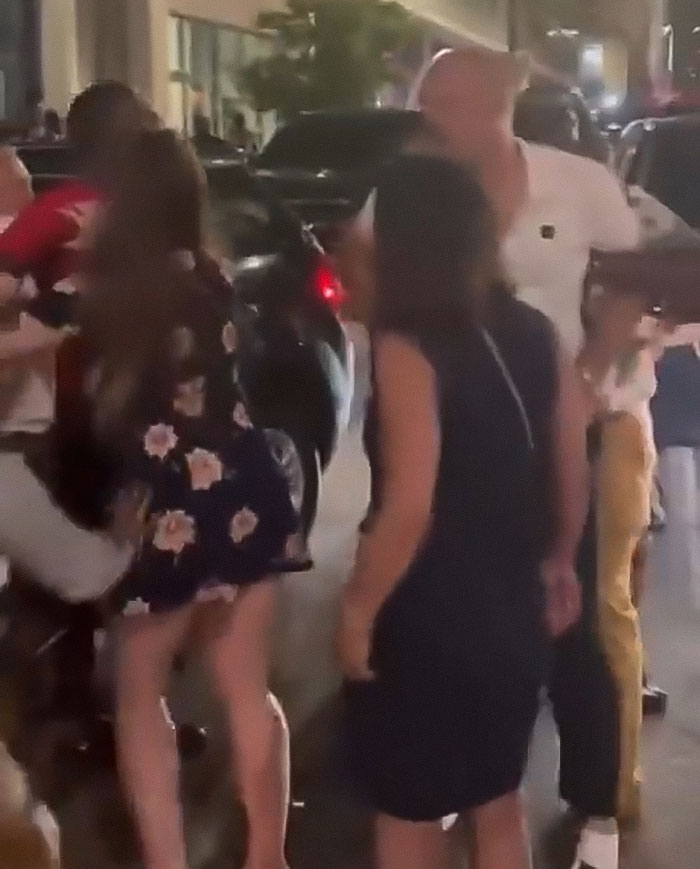 Crowd gathered on street at night as single mom confronts Cincinnati mob incident under police chief scrutiny.