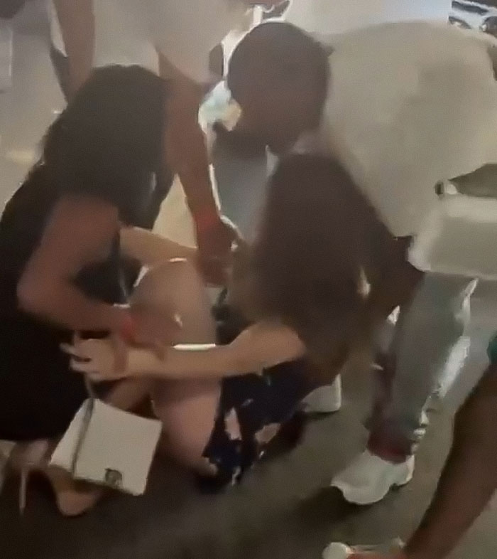 Single mom injured by Cincinnati mob being helped by bystanders in a chaotic public setting.