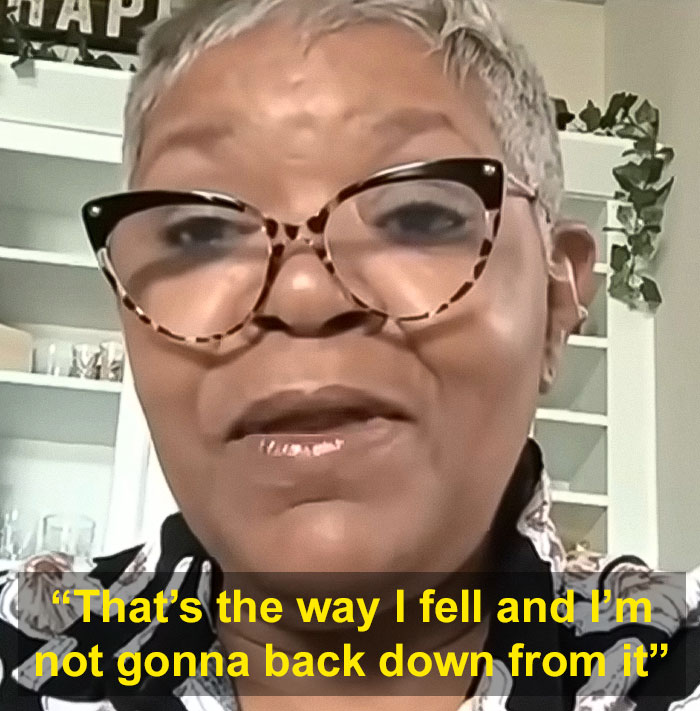 Woman with short gray hair and glasses speaking in front of a bookshelf, related to single mom beaten by Cincinnati mob.