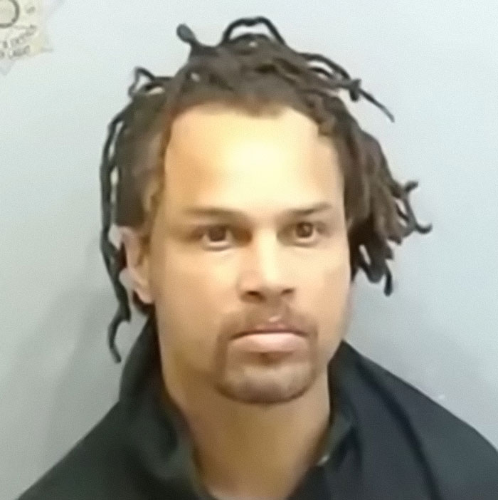 Mugshot of a man with dreadlocks wearing a dark jacket, related to Cincinnati mob attack on single mom incident.