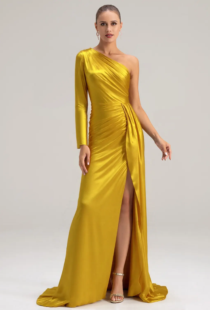 Elegant woman in a vibrant yellow one-shoulder gown with a thigh-high slit, posing gracefully against a neutral background.