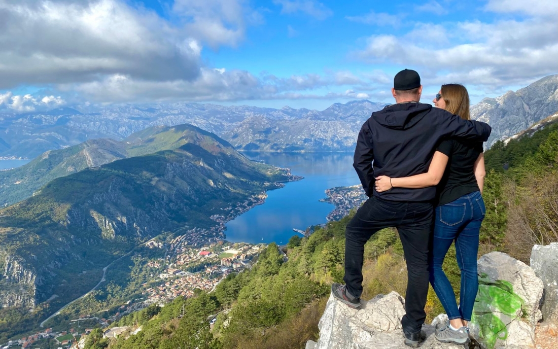 a picture of Nick and Dariece from Goats On The Road looking at a view over mountains