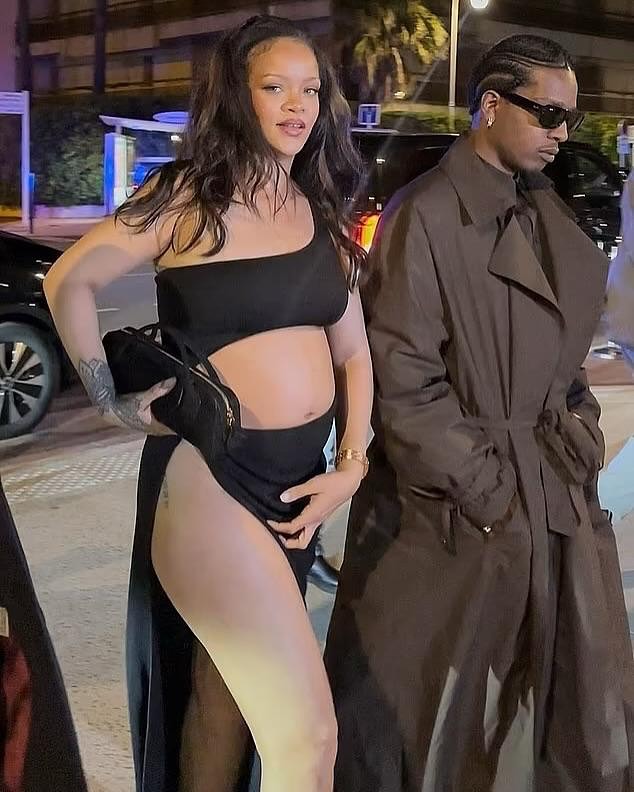 Rihanna Steps In A Black Cutout Alaia Maxi Dress With Beau AAP Rocky In A Brown Saint Laurent Trench Jacket In Cannes France 3