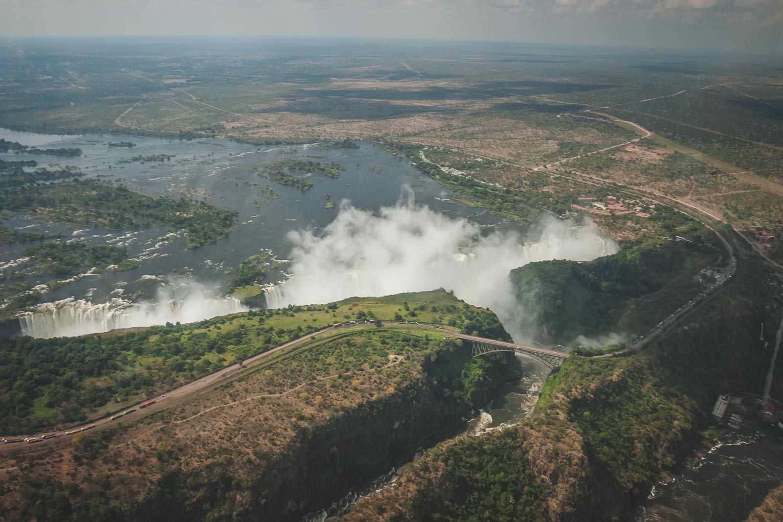 Victoria Falls waterfall with rainbow over Zambezi Gorge