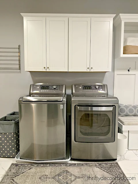 white cabinets above gray washer and dryer